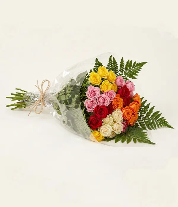 50 blooms of assorted spray roses in pink, yellow, red, orange, and cream with greenery, wrapped bouquet by Send Blooms