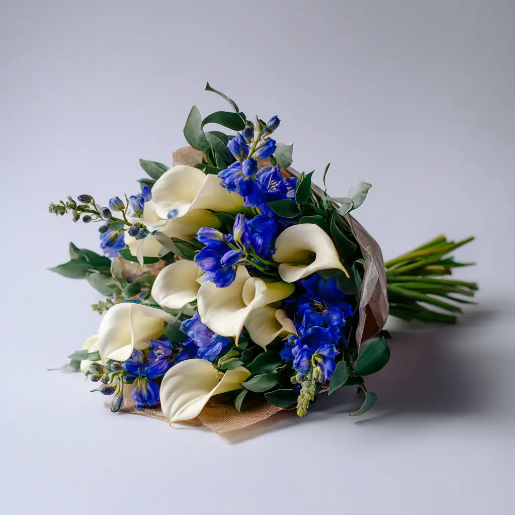 White Calla Lilies with Blue Bouquet Send Blooms