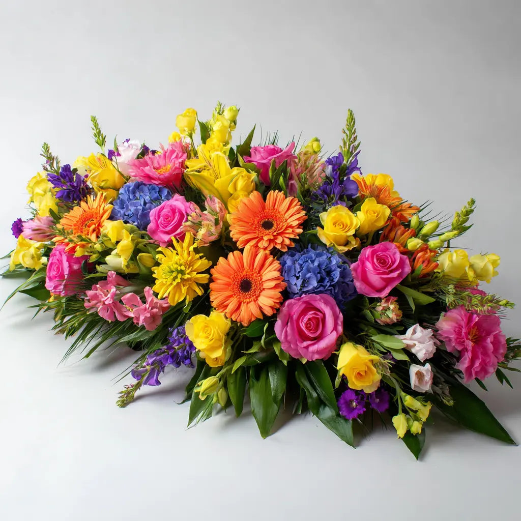 Colourfully Arranged Floral Casket Spray Send Blooms