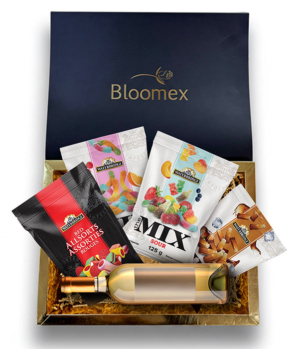 Gift box with white wine and a selection of candy